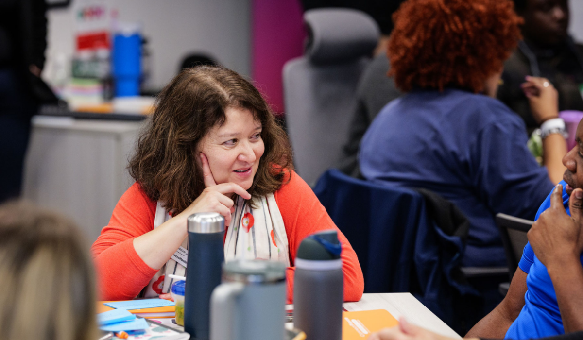 Elevate Health Executive Director Gena Morgan is smiling while she chats with attendees at a recent event at the Elevate Health office.
